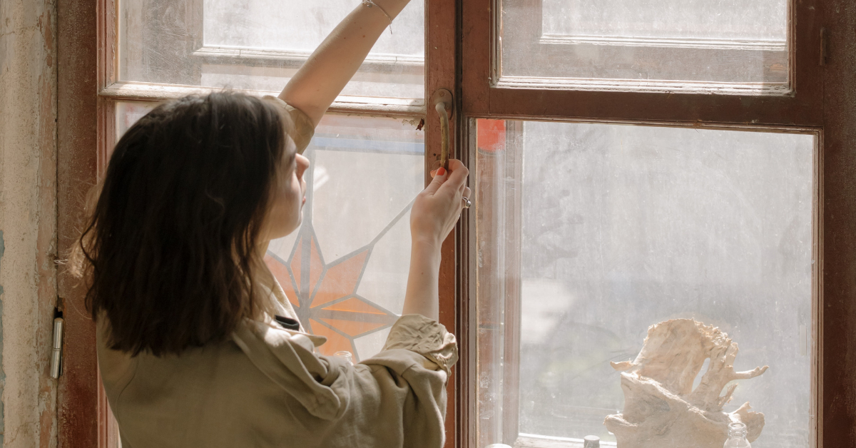 woman opening window